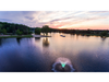 Aerial view of Scott Aerator North Star aerating pond fountain with green lighting at sunset