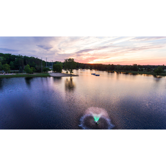 Aerial view of Scott Aerator North Star aerating pond fountain with green lighting at sunset
