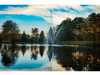 Atriarch Fountain by Scott Aerator spraying against a vivid sunset over a reflective pond