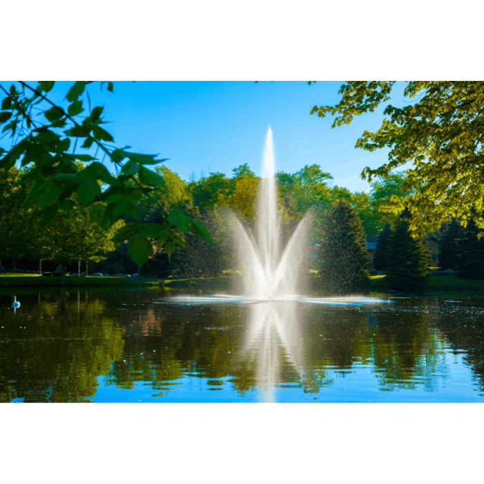 Atriarch Fountain by Scott Aerator spraying in a calm pond surrounded by green trees