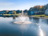 Bright lakeside view of the Scott Aerator Cambridge fountain in operation