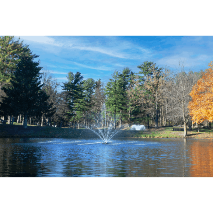 Cambridge Pond Fountain by Scott Aerator spraying in a tree-lined residential pond