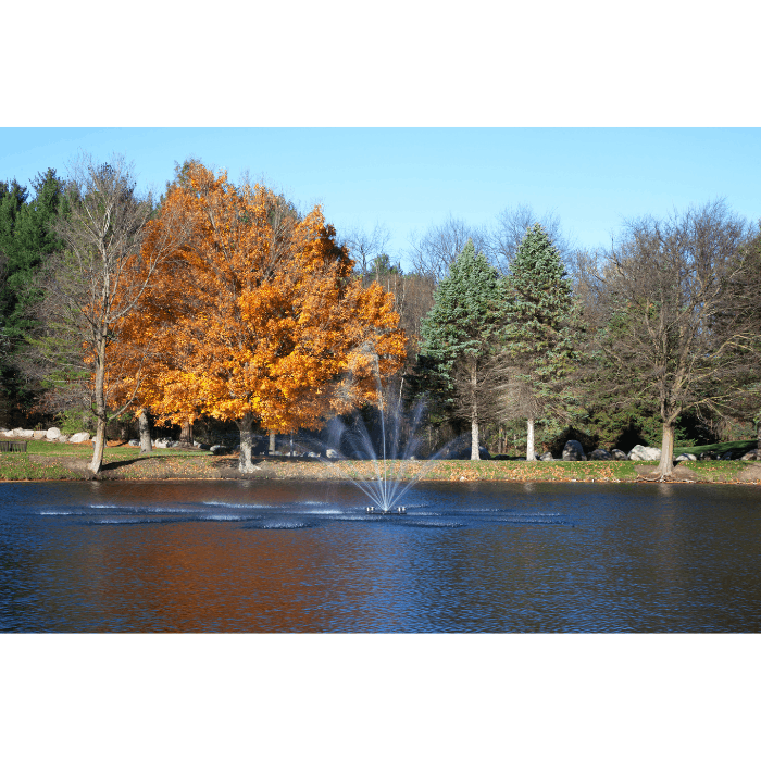 Cambridge Pond Fountain by Scott Aerator spraying in a tree-lined residential pond