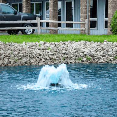 Close-up of the Scott Aerator Boilermaker aerator operating near a stone shoreline