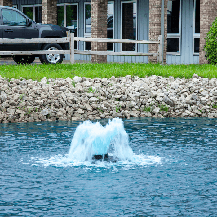 Close-up of the Scott Aerator Boilermaker aerator operating near a stone shoreline