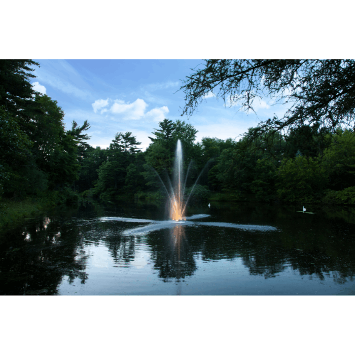 Clover Pond Fountain by Scott Aerator glowing at dusk on a wooded pond