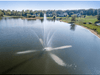 Clover Pond Fountain by Scott Aerator spraying across a large residential lake