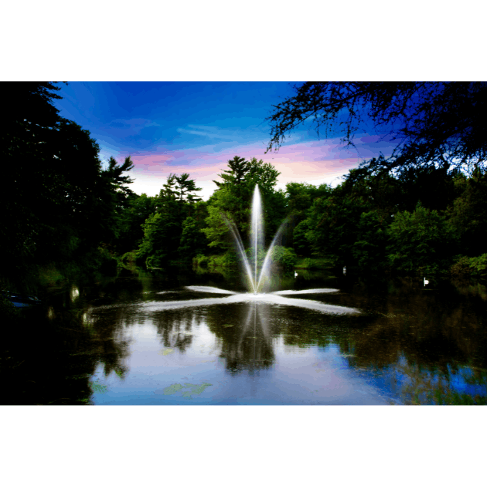 Clover display fountain by Scott Aerator creating a glowing evening spray pattern