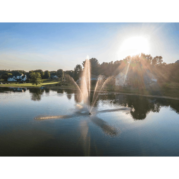 Clover fountain by Scott Aerator running in a neighborhood lake at sunset