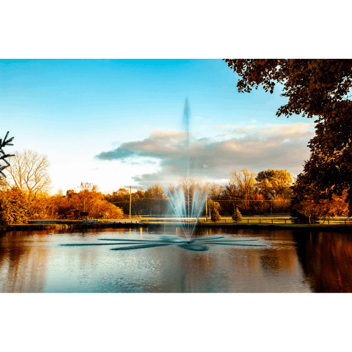 Golden-hour view of the Atriarch Fountain by Scott Aerator beside a garden shoreline