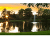 Gusher Pond Fountain by Scott Aerator glowing against a golden evening sky