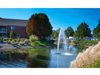 Gusher Pond Fountain by Scott Aerator operating in a landscaped pond beside an apartment building