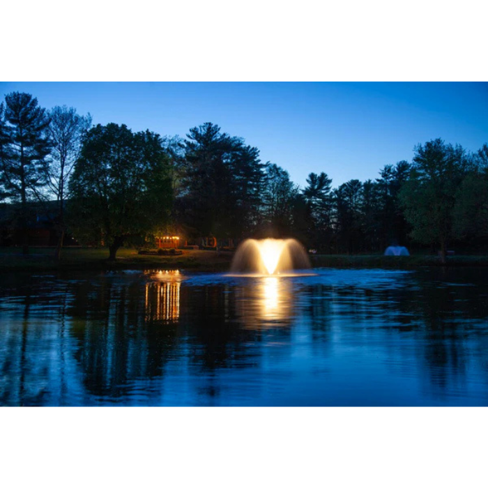 North Star aerating pond fountain by Scott Aerator illuminated with white LED lights at dusk