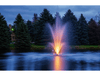 Scott Aerator Amherst Pond Fountain with warm LED lighting in a landscaped pond at dusk