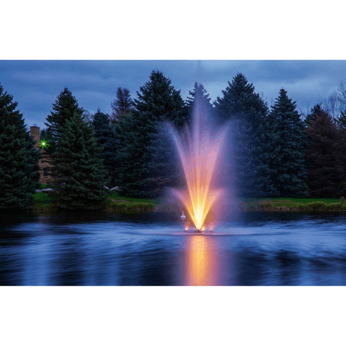 Scott Aerator Amherst Pond Fountain with warm LED lighting in a landscaped pond at dusk