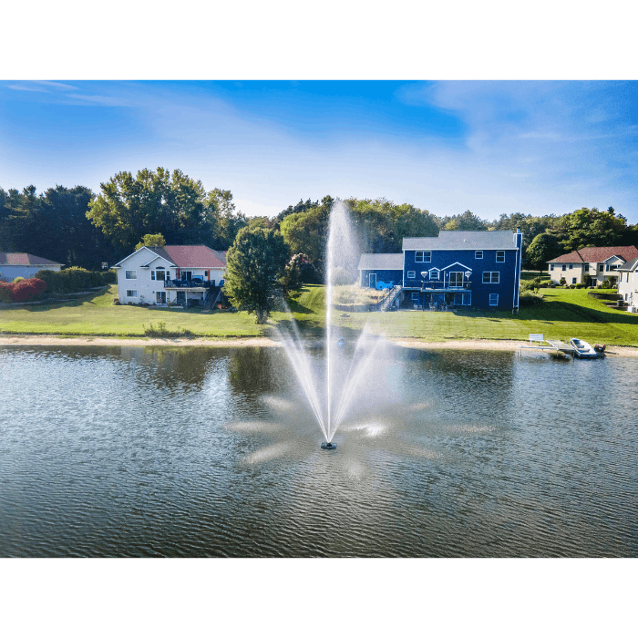 Scott Aerator Atriarch fountain spraying across a residential lake near shoreline houses