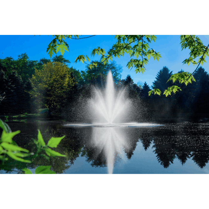 Scott Aerator Cambridge fountain framed by green leaves over a calm pond