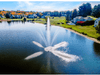 Scott Aerator Clover fountain creating a bright multi-stream display in a neighborhood pond