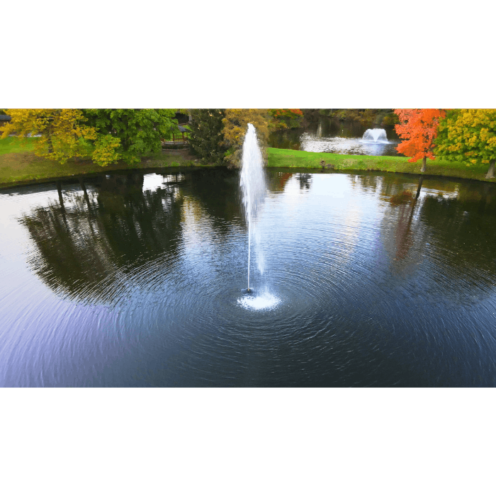 Scott Aerator Gusher fountain creating a tall geyser-style plume in a landscaped pond from above