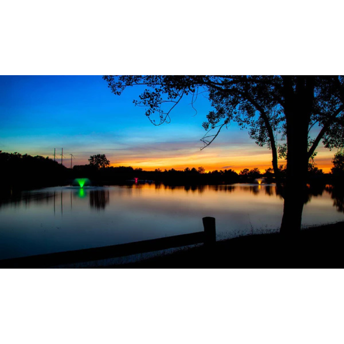 Scott Aerator North Star aerating pond fountain with color-changing lights on lake at dusk