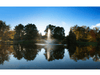 Scott Aerator Skyward fountain centered in a still lake with mirrored evening reflection