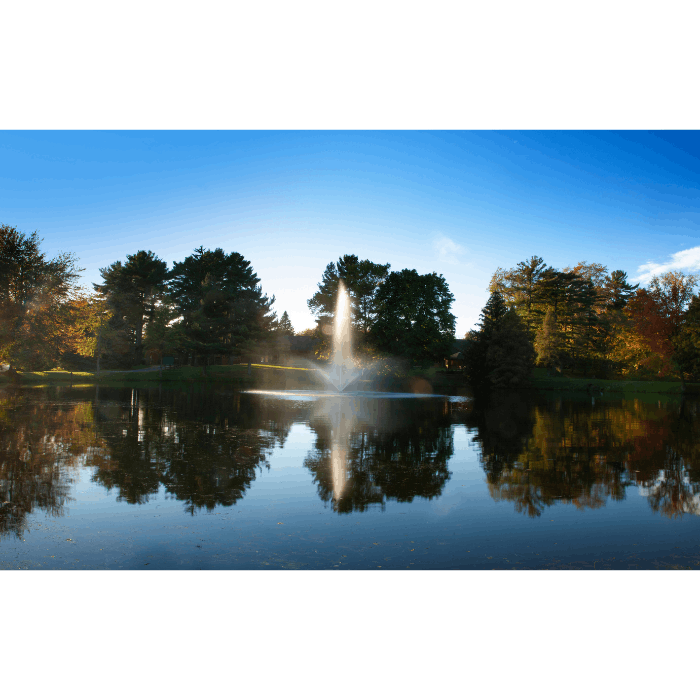 Scott Aerator Skyward fountain centered in a still lake with mirrored evening reflection