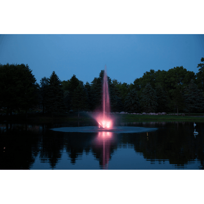 Scott Aerator Skyward fountain glowing pink at dusk on a calm pond
