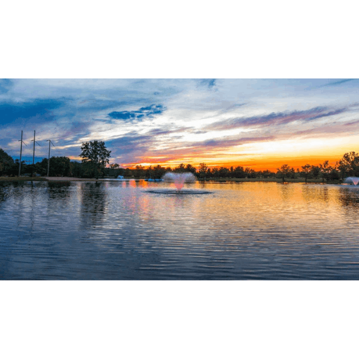 Scott Aerator color-changing LED light sets for fountains glowing on pond at sunset