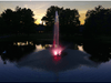 Skyward fountain by Scott Aerator running in a residential pond at golden hour