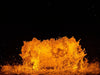 Close-up of WaterGlow RGB LED lighting creating amber illumination on fountain water splash at night