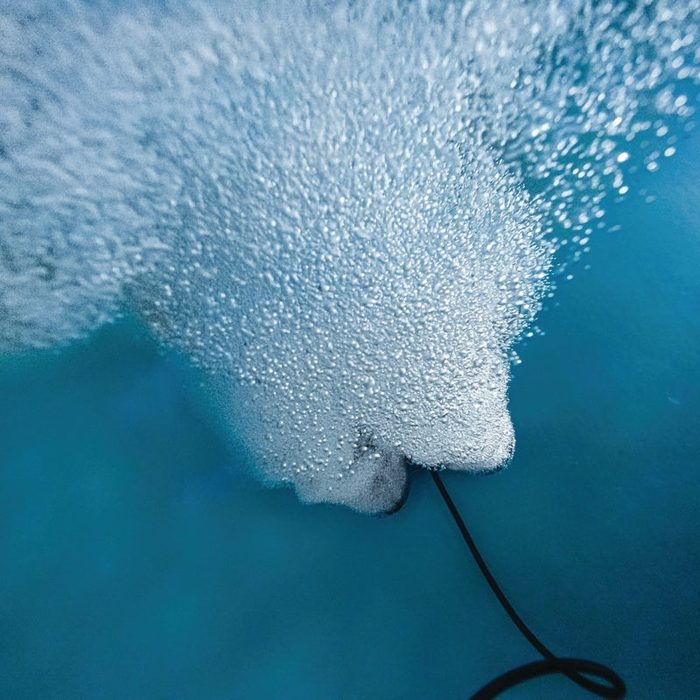 Close-up underwater view of Kasco Robust Aire diffuser releasing fine air bubbles for lake aeration