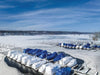 Frozen marina with boats covered for winter and open water areas maintained around docks using Kasco De-Icers