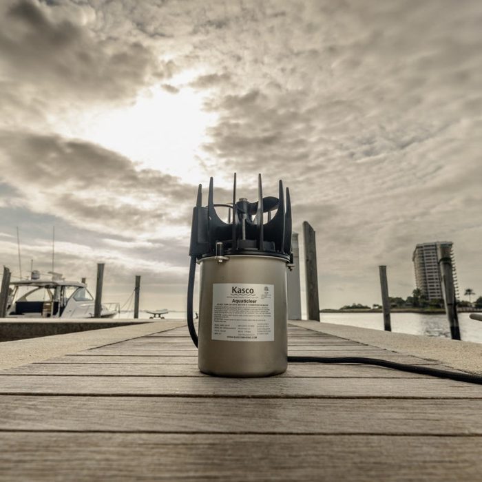 Kasco AquatiClear Circulator unit displayed on dock with marina and waterfront background