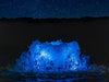 Kasco RGB LED creating a blue illuminated bubbling water feature under a night sky