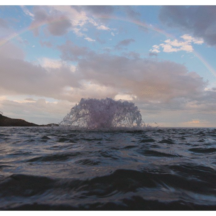 Kasco Surface Aerator Aerating on Water with Rainbow on the Background