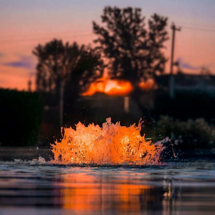 Kasco Surface Aerator with orange LED lighting reflecting on water at sunset