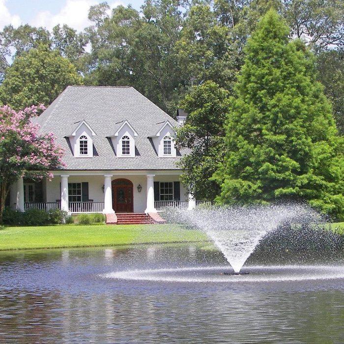Kasco VFX creating a wide spray pattern in a landscaped pond at a residential home