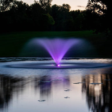 Kasco VFX illuminated with purple WaterGlow lights reflecting on a calm pond at dusk
