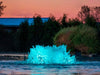 Kasco with teal LED lighting in pond at dusk