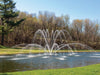 Premium Nozzle Magnolia nozzle - On water display in a pond with trees and grass in the background
