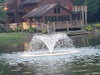Vanguard Typhoon 3/4 HP Floating Display Aerator On Water Display with Brown House at the Background