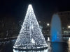 Floating Christmas Tree with White LED lights next to foutain with blue lights