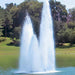 Vertex TriGeyser Floating Fountain on water with trees at the background