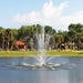 Vertex TriTier Floating Fountain Series On Water with Trees and Houses at the Background