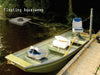 Scott Floating AquaSweep on water beside a boat, clearing the lakebed
