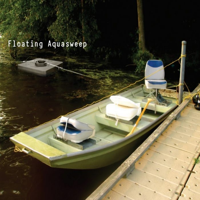 Scott Floating AquaSweep on water beside a boat, clearing the lakebed