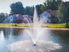 Scott Aerator Solar Amherst Fountain in a lake with houses and trees in the background