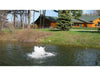 Scott Aerator Solar Boilermaker on a wooded pond with a cabin in the background