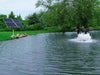 Scott Aerator Solar Boilermaker 3/4 HP with four solar panels beside the pond