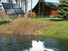 Scott Aerator Solar Boilermaker 3/4 HP running with four panels beside a house
